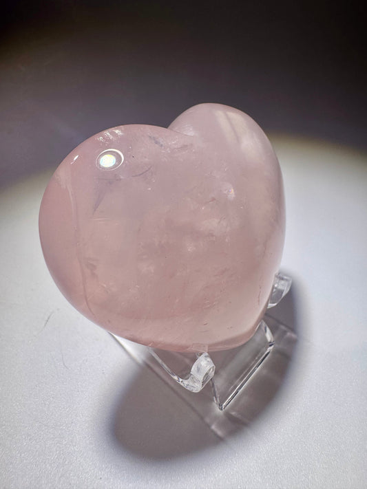 Edelsteinherz aus zartem Rosenquarz – hochglanzpoliert und doppelseitig gewölbt auf weissem Hintergrund