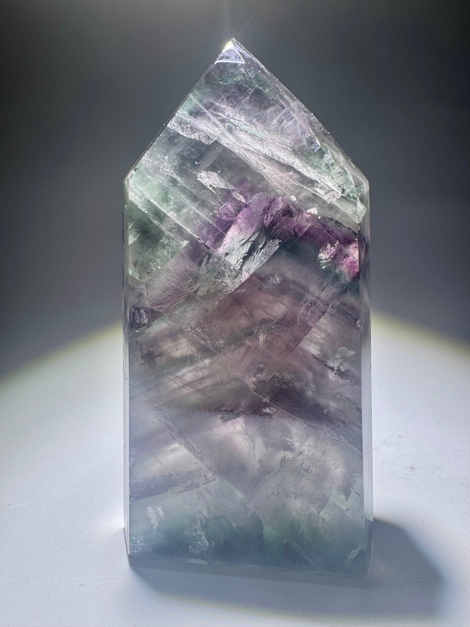 Fluoritkristall mit leuchtenden Grüntönen und violetten Einschlüssen aus Brasilien